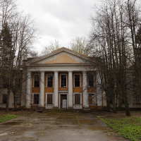 A large building with a lot of trees in the Daugavgrīva.