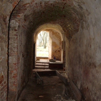 A Daugavgrīva-inspired tunnel with a wooden floor.