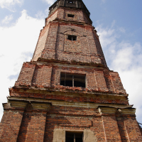 A Daugavgrīva brick tower with a bell.