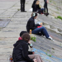 A group of people sitting on a Dzelzs vilks concert '09.