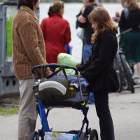 A woman pushing a stroller.