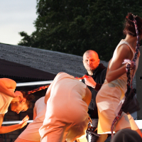 A group of people performing on a stage at Dzelzs vilks ielīgo '09.