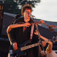 A man strumming a guitar.