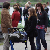A woman with a baby in a stroller Dzelzs vilks.