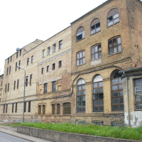 An old brick building in Iļģuciems.
