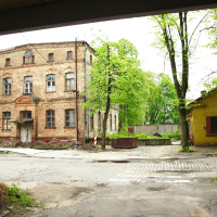A brick building in the middle of Iļģuciems.
