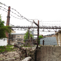 A Iļģuciems fence with barbed wire.