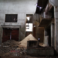 A building in Iļģuciems filled with rubble.
