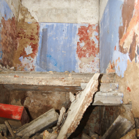 A demolished room in Iļģuciems covered in rubble.