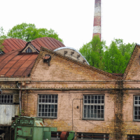 A Iļģuciems brick building with a chimney.