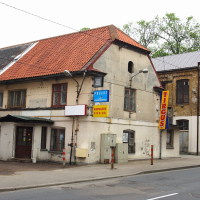 A Iļģuciems building with a tan roof.