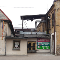 A Iļģuciems building with a sign on it.