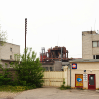 A Iļģuciems building on a street with a sign.