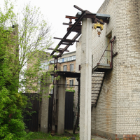 A Iļģuciems brick building with a stairway.