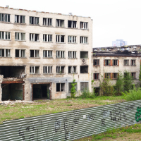 A Iļģuciems building with many windows.