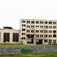 A graffitied building in Iļģuciems.