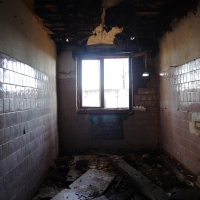 A broken window in a bathroom.