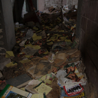 A Skulte room with a lot of papers on the floor.