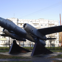 A Skulte-inspired statue of a fighter jet accentuates the facade of a building.