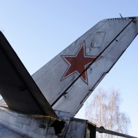 A silver airplane with a red star on the tail, identified as a Skulte.