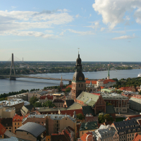 Aerial view of Riga showcasing a blue sky littered with white clouds.