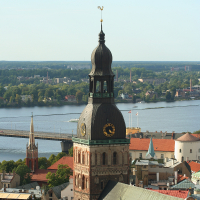 A brick building with a clock tower in Riga from above.