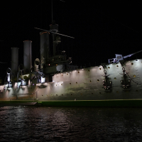 A large ship in the waters of St. Petersburg at night.