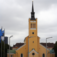 A yellow church in Tallinn with a steeple.