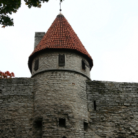 A clock adorns a stone wall in Tallinn.