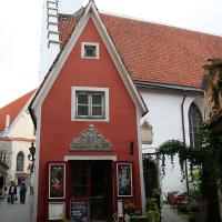 A red building with a clock tower in Tallinn.