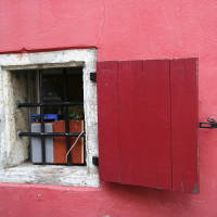 A red building with a window in Tallinn.