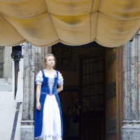 A tall girl in a dress exploring Tallinn.