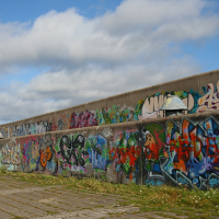 A graffiti-covered concrete wall in Tallinn.