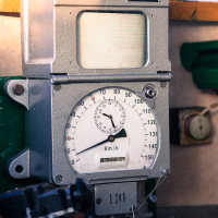 A boat featuring a meter alongside, resembling a train museum exhibit.