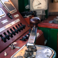 A train museum control panel with red and green lights.