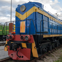A train museum exhibit showcasing a vibrant blue and yellow locomotive on the tracks.