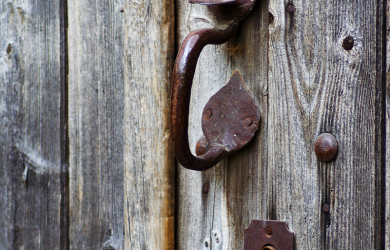 A Door With A Rusty Handle.