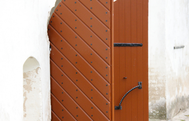 A Wooden Door With A Lamp Attached.