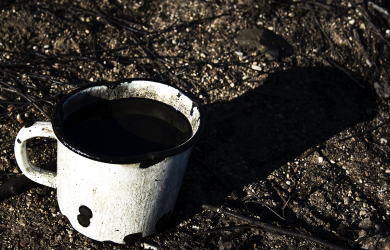 A Mug Of Coffee Sitting On The Ground.