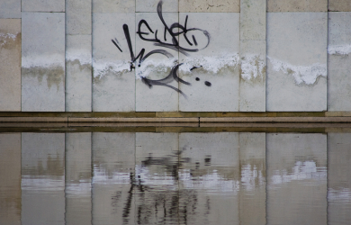 Graffiti Reflecting On A Concrete Wall.