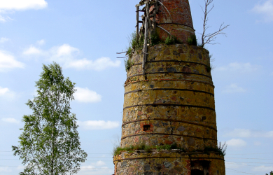 A Kiln Chimney In The Middle Of A Field.